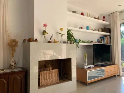 a living room with a fireplace and a tv at Villa Dacar in Cubelles