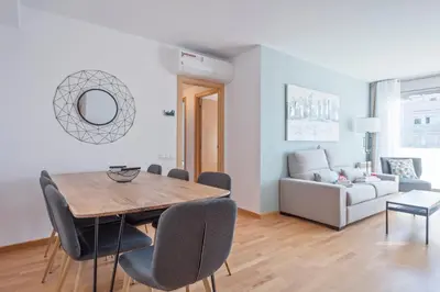 a living room with a table and chairs and a couch at Alcam Rubi in Rubí