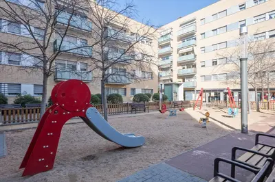 a playground in front of a building at Alcam Rubi in Rubí