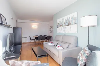 a living room with a couch and a tv at Alcam Rubi in Rubí
