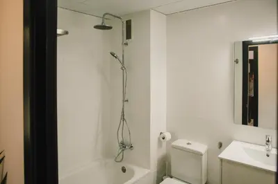 a bathroom with a shower and a toilet and a sink at BBarcelona Central Boutique Apartments in Barcelona