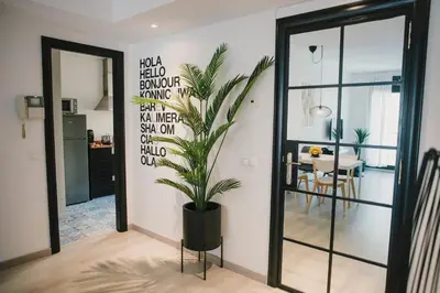 a potted plant in a room with a dining room at BBarcelona Central Boutique Apartments in Barcelona