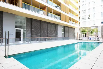 a swimming pool in front of a building at Cozy Home · Cozy Home · Nice apartment w/pool and private terrace in Mataró