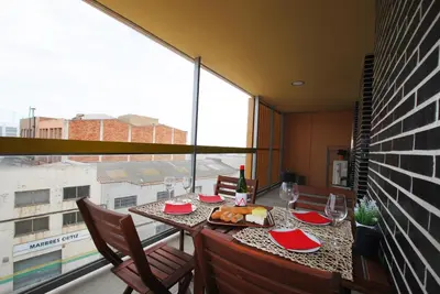 three swings in a playground in front of a building at Cozy Home · Cozy Home · Nice apartment w/pool and private terrace in Mataró