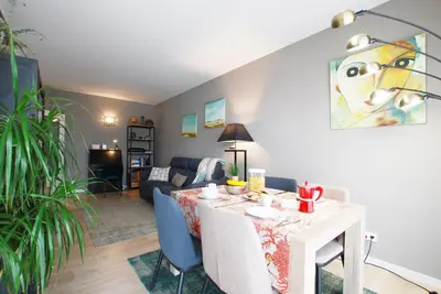 a living room with a blue couch and a flat screen tv at Cozy Home · Cozy Home · Nice apartment w/pool and private terrace in Mataró