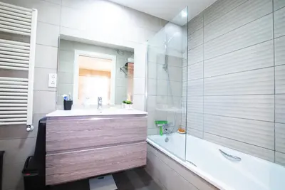 a small bedroom with a bed and a ladder at Cozy Home · Cozy Home · Nice apartment w/pool and private terrace in Mataró