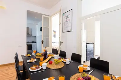 a dining room with a table with food on it at Key Plaza Universidad - Gran Via in Barcelona