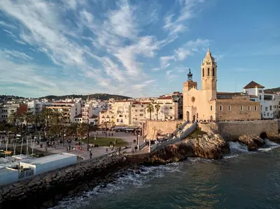 a view of a city with a river and a church at Vinyet Sitges in Sitges
