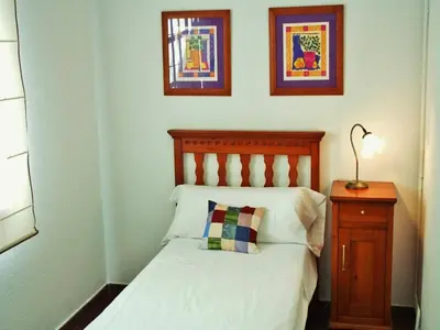 a bedroom with a bed with a pillow and a nightstand at Villa in Sant Pol near Crystal Beach in San Pol de Mar