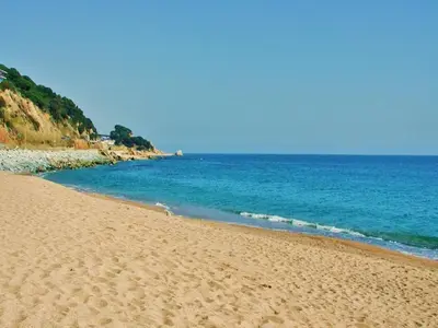 a sandy beach with the ocean in the background at Villa in Sant Pol near Crystal Beach in San Pol de Mar