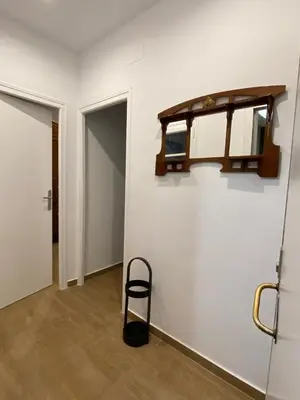 a room with a chair and a shelf on a wall at VIU BARCELONA BERTRAN in Barcelona