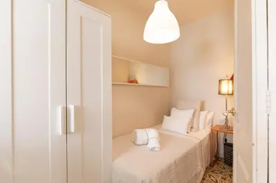 a bedroom with a bed with white sheets and pillows at Urban Apartments in Barcelona
