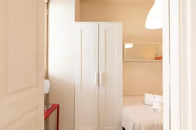 a small bedroom with a white closet and a bed at Urban Apartments in Barcelona