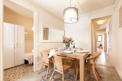 a dining room with a wooden table and chairs at Urban Apartments in Barcelona
