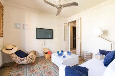 a living room with a couch and a tv at Urban Apartments in Barcelona