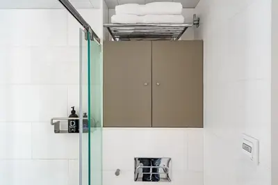 a shower with a glass door in a bathroom at Kronos on the Beach suite 1 in Barcelona