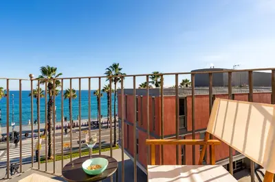 a balcony with a view of the beach at Kronos on the Beach suite 3 in Barcelona