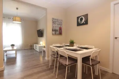 a dining room with a white table and chairs at FELIP - Spacious and quiet apartments & one with Terrace in Barcelona