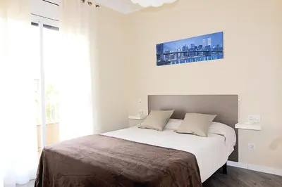 a bedroom with a large bed with white sheets at FELIP - Spacious and quiet apartments & one with Terrace in Barcelona