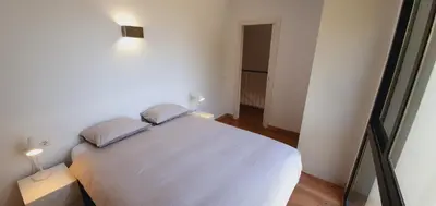 a bedroom with a white bed with two pillows at Villa Vicente in Canyelles