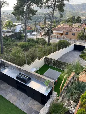 a house with a garden with a table at Villa Vicente in Canyelles
