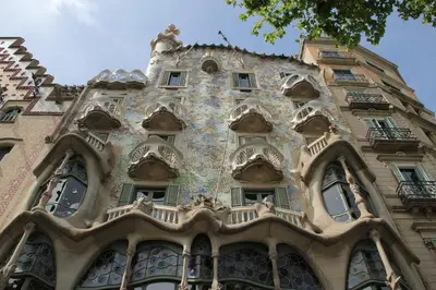 a tall building with windows on the side of it at MUNNE - Spacious apartments next to FC Barcelona in Barcelona