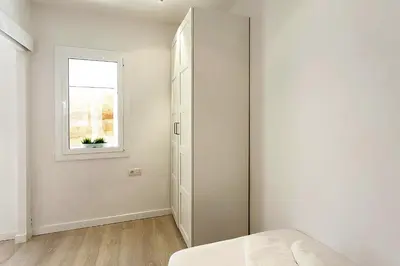 a bedroom with a closet and a window at MIQUEL ANGEL - Apartments & one with private terrace in Barcelona
