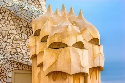 a wooden mask on the side of a building at MIQUEL ANGEL - Apartments & one with private terrace in Barcelona