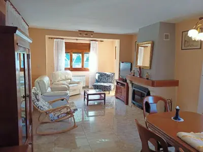 a living room with a couch and chairs and a television at Casa en Parque Natural del Montseny. in Santa María de Palautordera