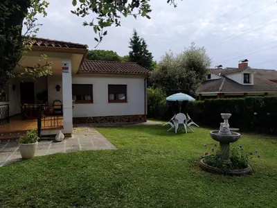 a garden with a fountain in the yard of a house at Casa en Parque Natural del Montseny. in Santa María de Palautordera