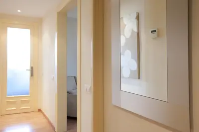 a hallway with a door with a picture on the wall at RIUS - Apartments & one Penthouse with private terrace in Montjuic in Barcelona