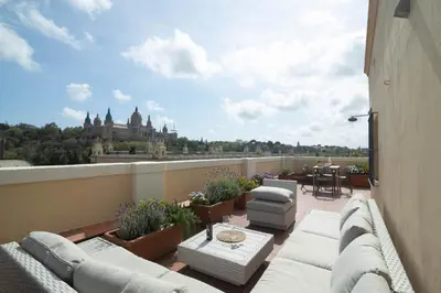 a balcony with couches and a view of a building at RIUS - Apartments & one Penthouse with private terrace in Montjuic in Barcelona