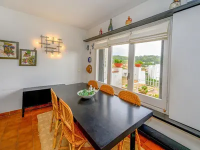 a dining room with a table and chairs and a window at Holiday Home La Marina Blanca by Interhome in San Pol de Mar