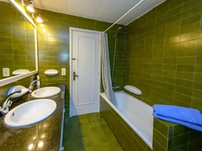 a bathroom with two sinks and a bath tub at Holiday Home La Marina Blanca by Interhome in San Pol de Mar