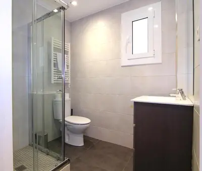 a bathroom with a toilet and a glass shower at GIRONA - Modernist apartments next to Paseo de Gracia in Barcelona