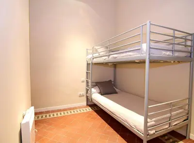 a room with two bunk beds in a room at GIRONA - Modernist apartments next to Paseo de Gracia in Barcelona