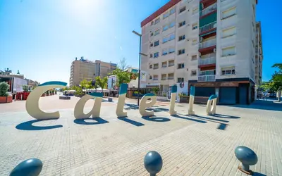 a large sign on a sidewalk in a city at HomeHolidaysRentals Moana in Calella