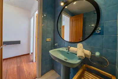 a bathroom with a sink and a mirror at HomeHolidaysRentals Elodie in Calella