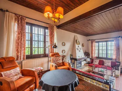 a living room with a table and chairs at Villa in Maresme near Montnegre Park in Sant Iscle de Vallalta