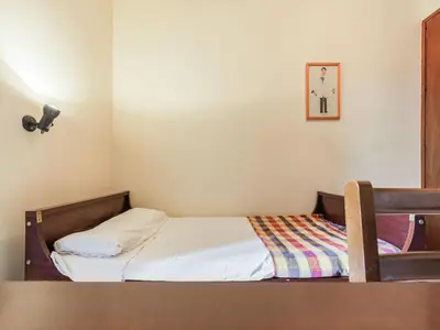 a small bedroom with a bed and a table at Villa in Maresme near Montnegre Park in Sant Iscle de Vallalta