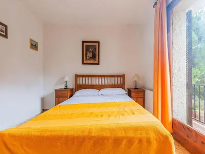 a bedroom with a large yellow bed and a window at Villa in Maresme near Montnegre Park in Sant Iscle de Vallalta