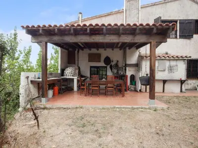 a pergola on a patio in front of a house at Villa in Maresme near Montnegre Park in Sant Iscle de Vallalta