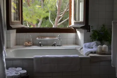 a bath tub in a bathroom with a window at Mas Peirot Sitges in Cunit