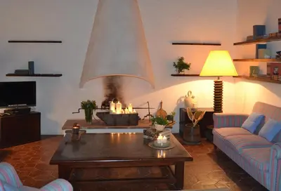 a living room with a fireplace and a coffee table at Mas Peirot Sitges in Cunit