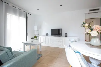 a bedroom with a bed with a wooden headboard at INASS in Sitges