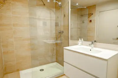 a bathroom with a sink and a shower at La Gioia 1 by Hello Homes Sitges in Sitges