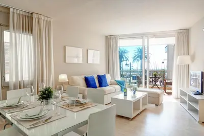 a living room with a table and a couch at La Gioia 1 by Hello Homes Sitges in Sitges