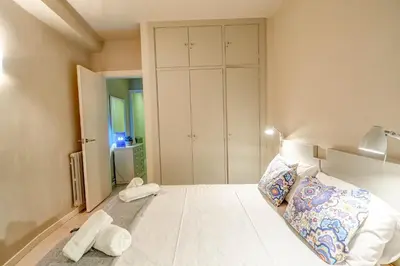 a bedroom with a bed and a large closet at La Gioia 1 by Hello Homes Sitges in Sitges