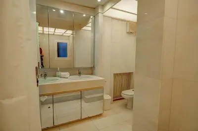 a bathroom with a sink and a toilet and a mirror at La Gioia 2 by Hello Homes Sitges in Sitges