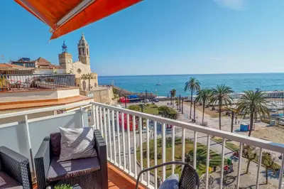 a balcony with chairs and a view of the ocean at La Gioia 3 by Hello Homes Sitges in Sitges